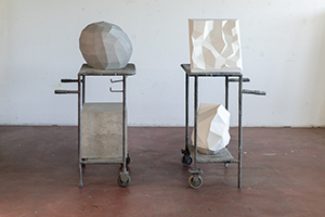 Sandro Steudler, Sculptural Side Trolley I (Light Funnel, Light Peak II), 2025, and Sculptural Side Trolley II (Erratic Block, Volume), 2025. Concrete, iron, 127 x 58 x 54 cm, and 124 x 60 x 52 cm